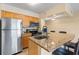 The kitchen features stainless steel appliances, granite countertops, and an island with seating at 2506 N Rocky Point Dr # 272, Tampa, FL 33607