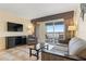 Relaxing living room with comfortable seating, TV, and balcony overlooking the waterfront at 2506 N Rocky Point Dr # 272, Tampa, FL 33607