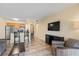 Living room with chairs, breakfast bar and kitchen and TV at 2506 N Rocky Point Dr # 272, Tampa, FL 33607