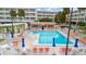 The complex features a sparkling blue pool, surrounded by a patio, seating, and sun umbrellas at 2506 N Rocky Point Dr # 272, Tampa, FL 33607