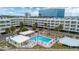 A swimming pool is the focal point of the complex, surrounded by lounge chairs and umbrellas at 2506 N Rocky Point Dr # 272, Tampa, FL 33607
