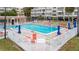 Resort-style pool area featuring lounge chairs, umbrellas, and a white fence at 2506 N Rocky Point Dr # 272, Tampa, FL 33607