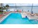 A large swimming pool is surrounded by comfortable lounge chairs and picturesque ocean views at 2506 N Rocky Point Dr # 272, Tampa, FL 33607