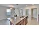 Kitchen island featuring granite countertops, stainless steel sink, and modern faucet at 6834 Blue Moon Way, Sun City Center, FL 33573