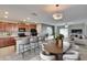 Open-concept kitchen and living area featuring modern countertops, dining space, barstool seating, and cozy living area at 6834 Blue Moon Way, Sun City Center, FL 33573