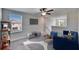 Comfortable carpeted loft with a ceiling fan and lots of natural light at 6834 Blue Moon Way, Sun City Center, FL 33573