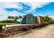 Cypress Creek community entrance sign surrounded by lush landscaping and palm trees at 6834 Blue Moon Way, Sun City Center, FL 33573