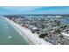 Scenic aerial view of the coastline featuring white sandy beaches, clear turquoise waters, and coastal community at 6950 113Th St, Seminole, FL 33772