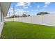 Private backyard with tall fence, offering a serene and secure outdoor space with green grass at 6950 113Th St, Seminole, FL 33772