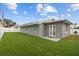 The house features a gray exterior with a spacious backyard and white fencing at 6950 113Th St, Seminole, FL 33772