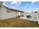 The backyard features a patio with a table and chairs, and gray grass at 6950 113Th St, Seminole, FL 33772