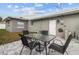 Cozy backyard patio with seating, ideal for outdoor dining and relaxation with gray grass at 6950 113Th St, Seminole, FL 33772