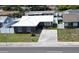 Charming single-story brick home with a well-manicured lawn, bright white roof, and inviting curb appeal at 6950 113Th St, Seminole, FL 33772