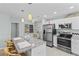 Bright kitchen with stainless steel appliances, granite countertops, and white cabinets, open to the living area at 6950 113Th St, Seminole, FL 33772