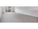 Bright living room with sliding glass doors and neutral carpeting at 1311 Powderpuff Dr # 4, Dunedin, FL 34698