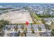 Expansive aerial perspective of the neighborhood with houses, a construction area, and a distant waterway at 302 Latitude Pl, Apollo Beach, FL 33572