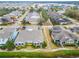 Aerial view of a residential neighborhood with houses, roads, and a serene lake in the distance at 302 Latitude Pl, Apollo Beach, FL 33572