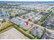 Aerial view showcasing a charming community with lush landscaping, serene lakes, and inviting residences at 302 Latitude Pl, Apollo Beach, FL 33572