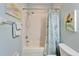 Shower and tub with a blue shower curtain, as well as a toilet in this bathroom at 302 Latitude Pl, Apollo Beach, FL 33572