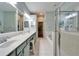 Bathroom boasts double sinks, large mirrors, a tiled floor and shower, plus a soaking tub at 302 Latitude Pl, Apollo Beach, FL 33572