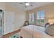 Bright bedroom with shuttered windows, wood floors, and neutral-toned decor at 302 Latitude Pl, Apollo Beach, FL 33572
