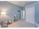Bedroom featuring light blue walls, white trim, a rocking horse, and decorative shelving at 302 Latitude Pl, Apollo Beach, FL 33572