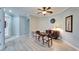 Well-lit dining area with a round table set, accompanied by a vintage buffet and decorative clock at 302 Latitude Pl, Apollo Beach, FL 33572