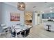 Open-concept kitchen and dining area with modern bar stools and retro dining furniture at 302 Latitude Pl, Apollo Beach, FL 33572