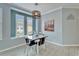 Charming dining area with a modern chandelier, white shutters, and coastal-themed artwork at 302 Latitude Pl, Apollo Beach, FL 33572