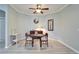 Cozy dining area features a ceiling fan and a small table set for two in a well lit dining space at 302 Latitude Pl, Apollo Beach, FL 33572
