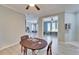 Inviting dining space with a dark wood table set for cards, adjacent to other living spaces at 302 Latitude Pl, Apollo Beach, FL 33572