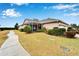 Wide angle view of the rear home exterior featuring a screened lanai and landscaped grounds at 302 Latitude Pl, Apollo Beach, FL 33572