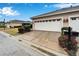Property displaying a two-car garage with a clean driveway and a well-maintained lawn at 302 Latitude Pl, Apollo Beach, FL 33572
