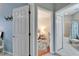 Hallway leading to a bedroom and bathroom with neutral walls and white trim at 302 Latitude Pl, Apollo Beach, FL 33572