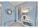 Hallway featuring coastal decor, a decorative mirror, and a cushioned bench at 302 Latitude Pl, Apollo Beach, FL 33572