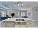 Spacious kitchen with a center island and open to the living area with light-colored plank flooring at 302 Latitude Pl, Apollo Beach, FL 33572
