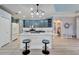 Kitchen with shaker cabinets, white countertops, and an island with stool seating at 302 Latitude Pl, Apollo Beach, FL 33572