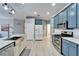Kitchen with shaker cabinets, stainless steel appliances, and plank flooring at 302 Latitude Pl, Apollo Beach, FL 33572