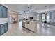 An open concept kitchen features a large island with a stainless steel sink at 302 Latitude Pl, Apollo Beach, FL 33572
