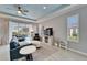 Comfortable living room featuring a plush sofa, armchair, and access to an outdoor patio space at 302 Latitude Pl, Apollo Beach, FL 33572