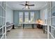 Office with a large desk, shutters, light-colored walls, and a piano at 302 Latitude Pl, Apollo Beach, FL 33572