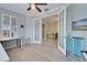 Bright office features a ceiling fan and lots of natural light with adjacent dining area through glass french doors at 302 Latitude Pl, Apollo Beach, FL 33572