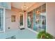 Covered patio showcasing sliding glass doors, a chandelier, and an elegant mermaid wall decor at 302 Latitude Pl, Apollo Beach, FL 33572