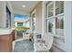 Cozy screened porch featuring comfortable wicker seating and charming outdoor decor at 302 Latitude Pl, Apollo Beach, FL 33572