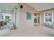 Inviting screened porch area with wicker chairs, enhancing the home's curb appeal at 302 Latitude Pl, Apollo Beach, FL 33572