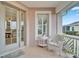 Inviting porch area with wicker chair, creating a relaxing entryway at 302 Latitude Pl, Apollo Beach, FL 33572
