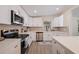 Newly renovated kitchen featuring stainless steel appliances, white cabinets, and quartz countertops at 3152 Karen Ave, Largo, FL 33774