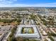 Attractive aerial view of a condo community with a courtyard pool, manicured landscaping, and ample parking at 4746 Azalea Dr # 105C, New Port Richey, FL 34652