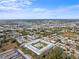 Sprawling aerial view of a condo community featuring a central pool, bocce court, and lush landscaping at 4746 Azalea Dr # 105C, New Port Richey, FL 34652