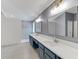 A spacious bathroom features a double vanity with quartz countertops and a walk-in shower at 5608 Rockfield Loop, Valrico, FL 33596